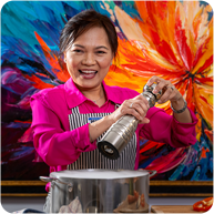 Linh T. Nguyen cooking in colorful setting