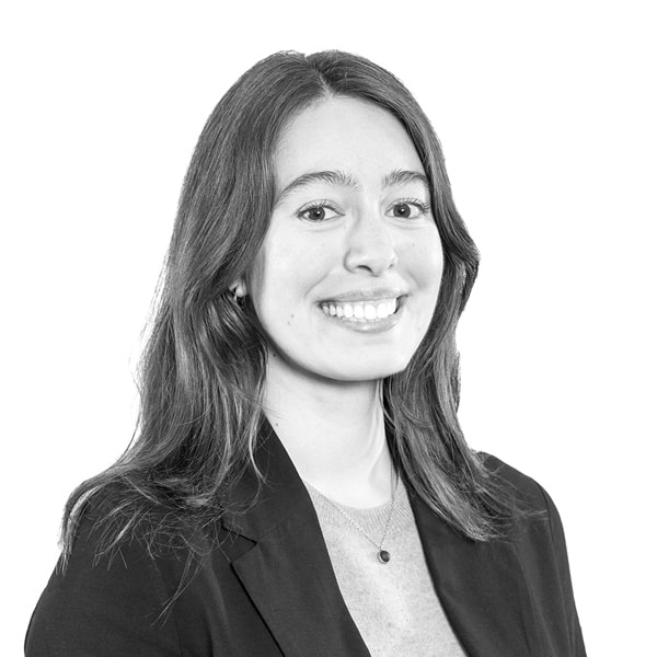 Emma Schneider reading a book with a coffee cup and blanket